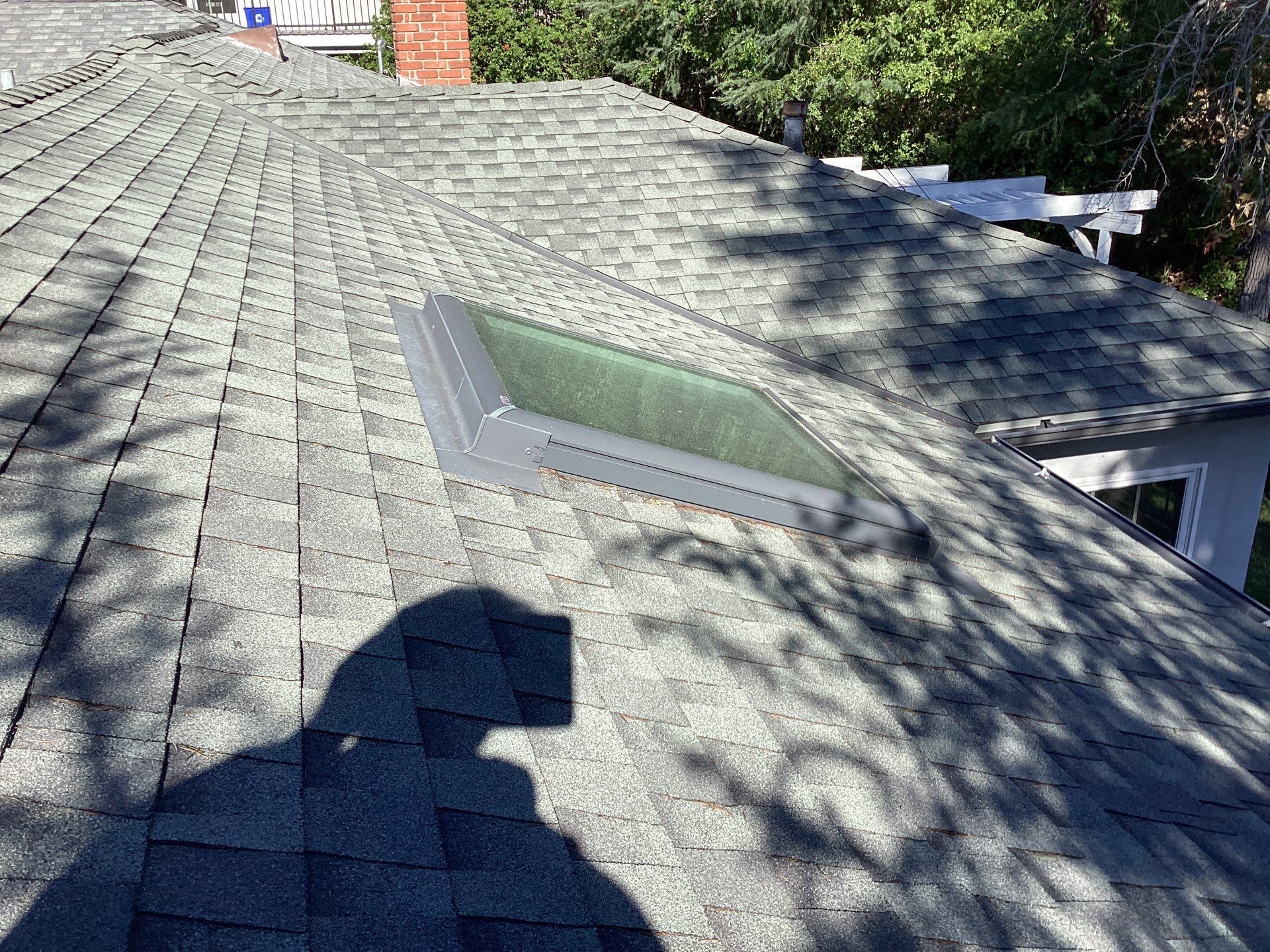 Skylight installed on shingled residential roof