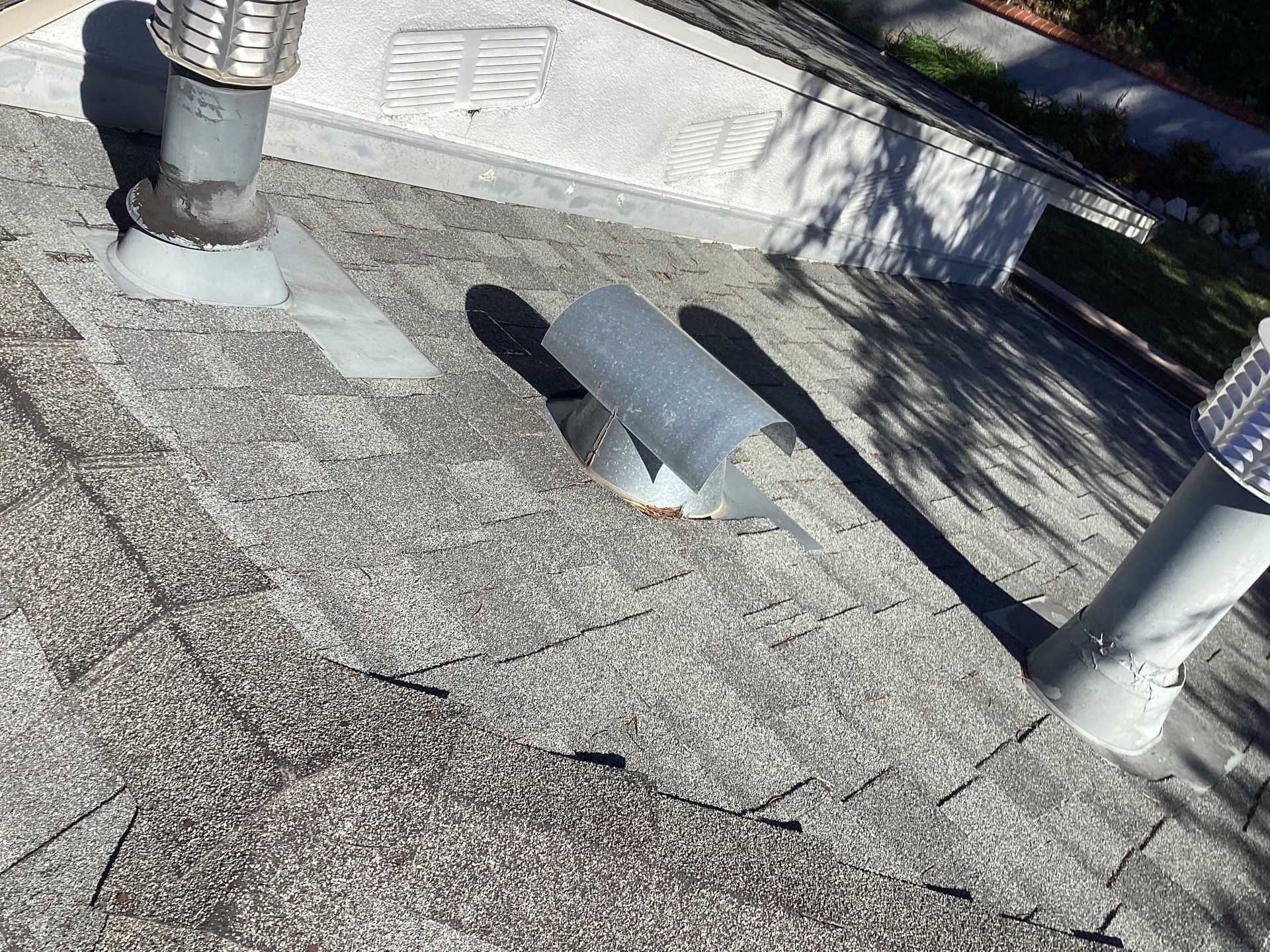 Residential roof with metal vents and shingles