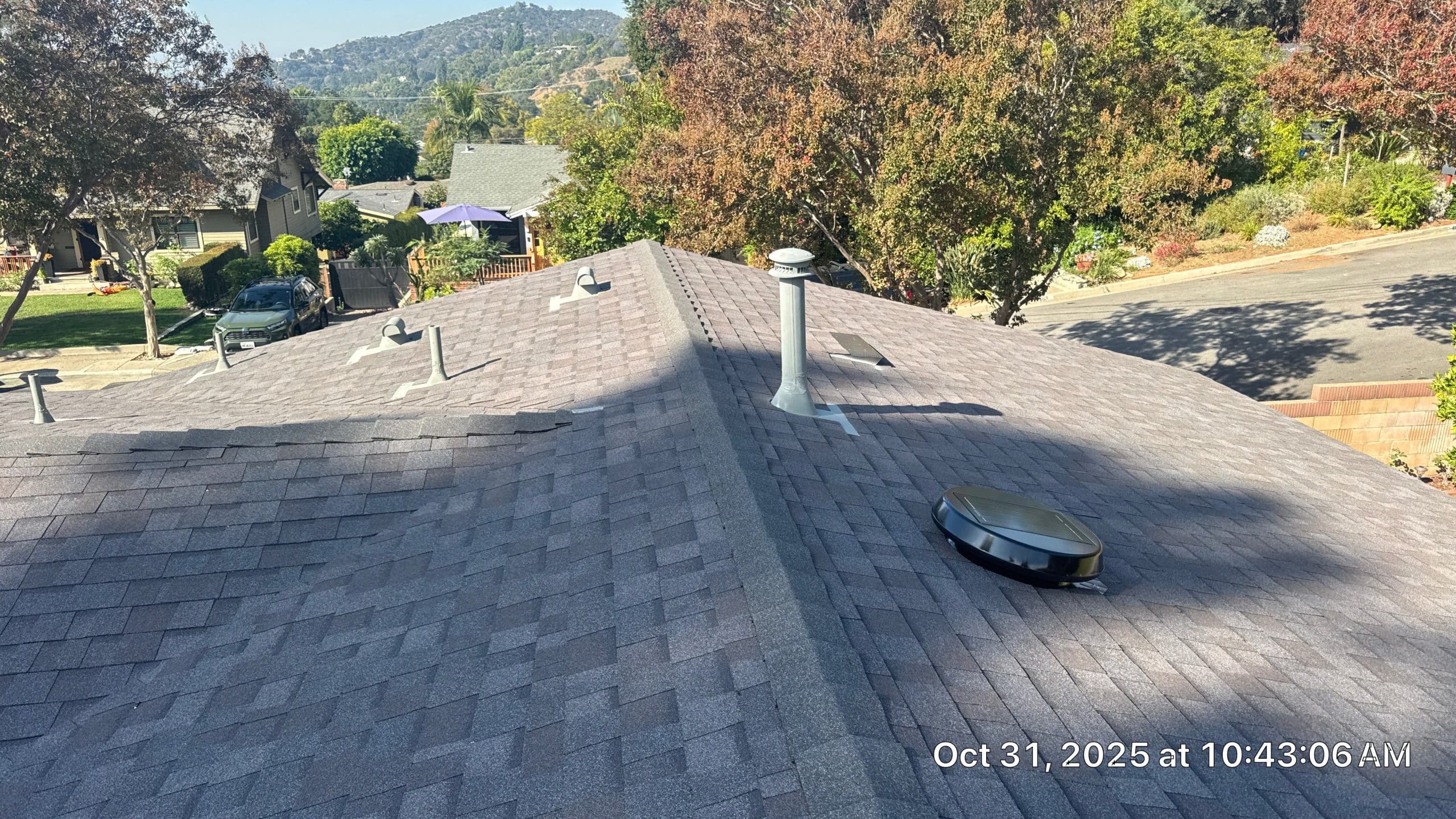 Asphalt shingle roof with vents and solar fan