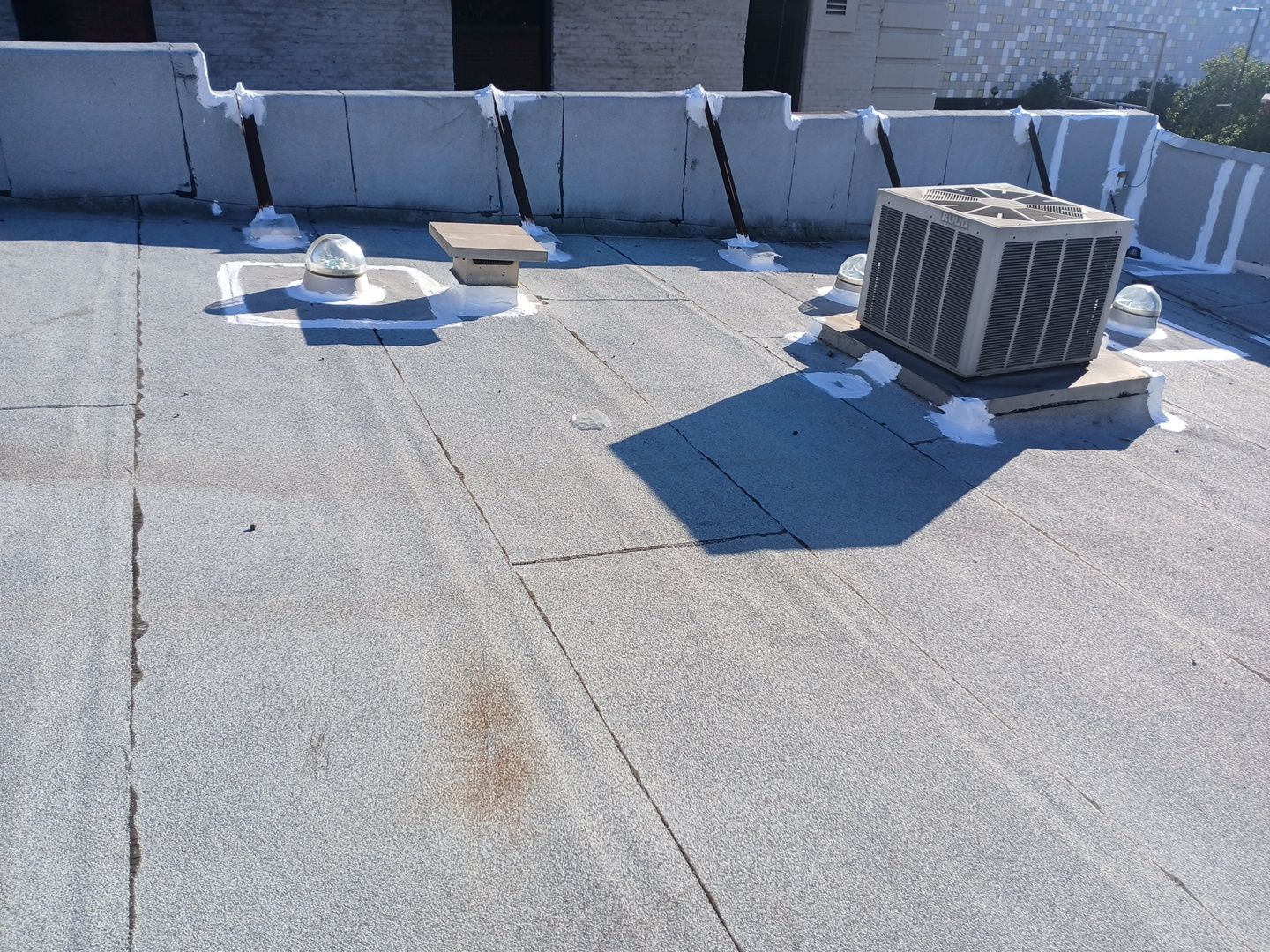 Flat commercial rooftop with HVAC unit and vents