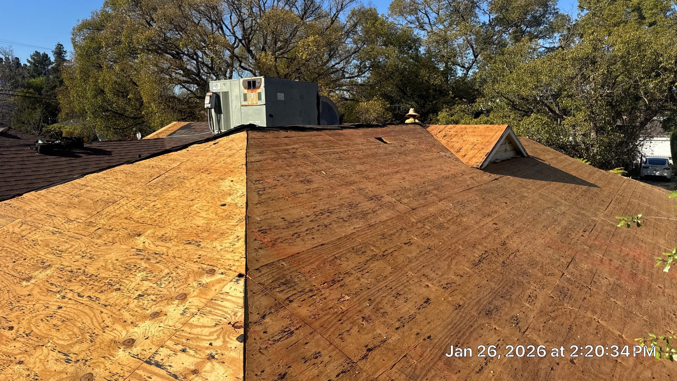 Roof under renovation with exposed plywood sheathing