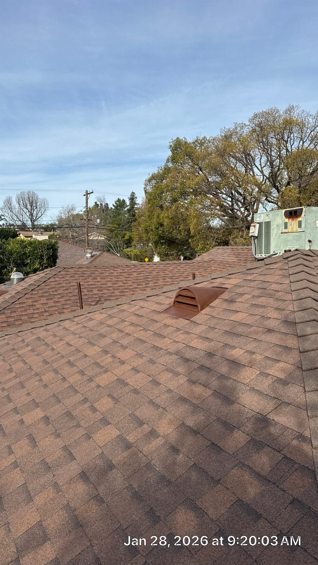 Brown asphalt shingle roof with dormer vent and rooftop HVAC unit | Roof Replacement Inc Brown asphalt shingle roof with dormer vent and rooftop HVAC unit — Roof Replacement Inc