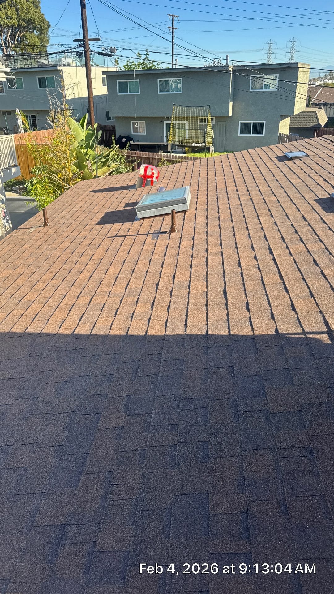Asphalt shingle roof with skylight, two-tone new and existing shingles — Roof Replacement Inc