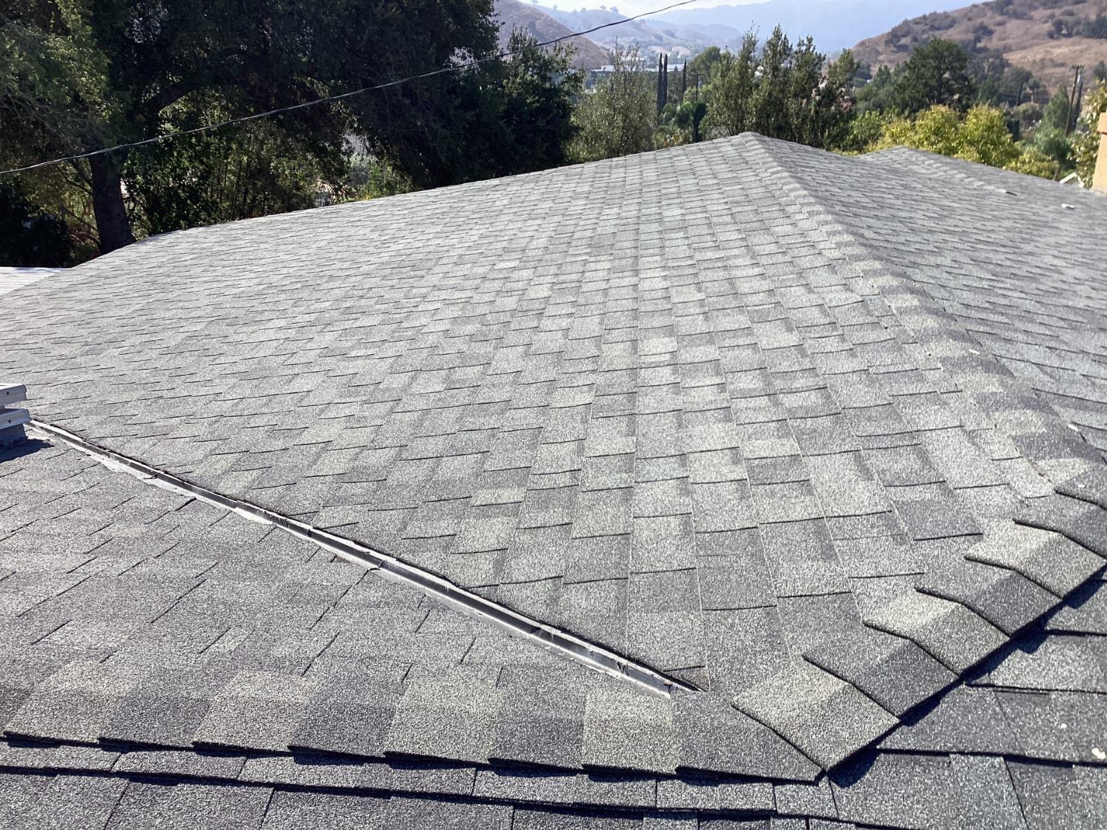 Gray asphalt shingle hip roof with ridge vent installed in Calabasas | Roof Replacement Inc gray asphalt shingle hip roof with ridge vent installed — Calabasas — Roof Replacement Inc