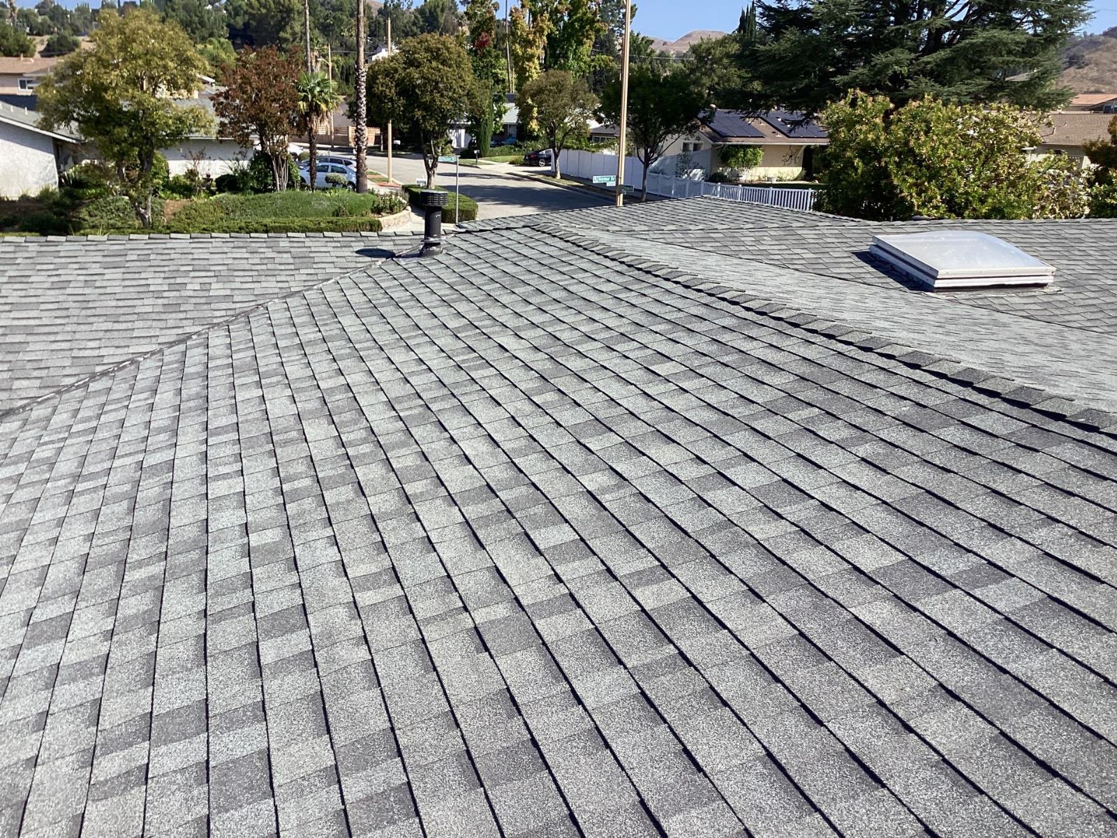 Gray asphalt shingle roof with skylight and vent pipe in Calabasas | Roof Replacement Inc gray asphalt shingle roof with skylight and vent pipe — Calabasas — Roof Replacement Inc