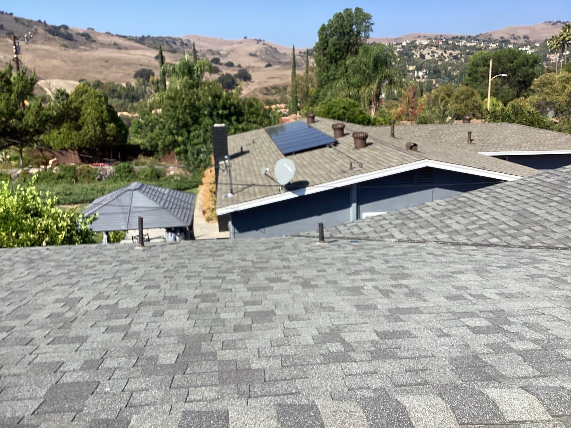 Gray asphalt shingle roof with solar panels and satellite dish in Calabasas | Roof Replacement Inc gray asphalt shingle roof with solar panels and satellite dish — Calabasas — Roof Replacement Inc