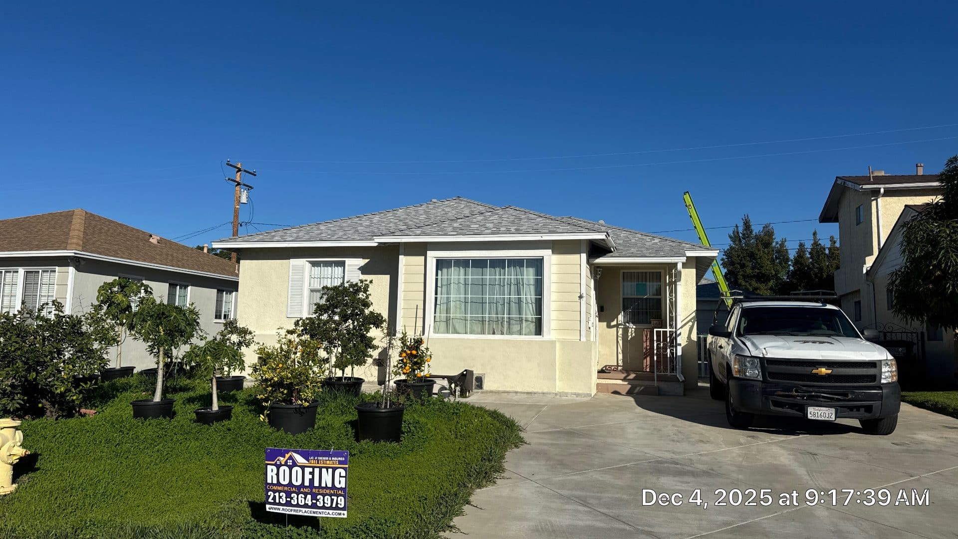 Hip roof with gray asphalt shingles, stucco house, roofing truck with ladder | Roof Replacement Inc Hip roof with gray asphalt shingles, stucco house, roofing truck with ladder — Roof Replacement Inc