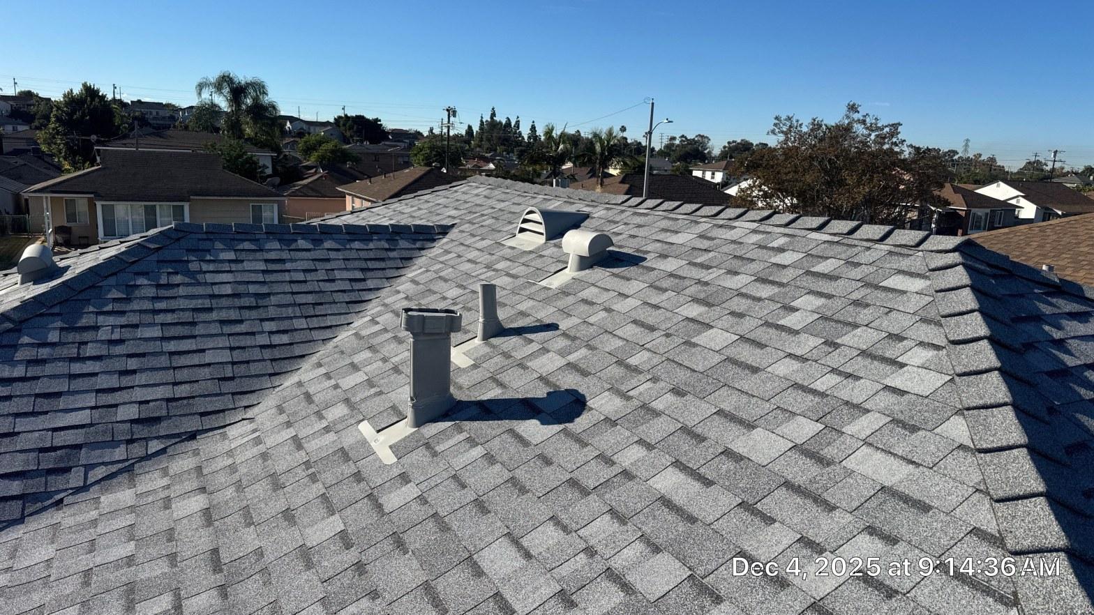 Dark asphalt shingle roof absorbing heat under bright Southern California summer sun