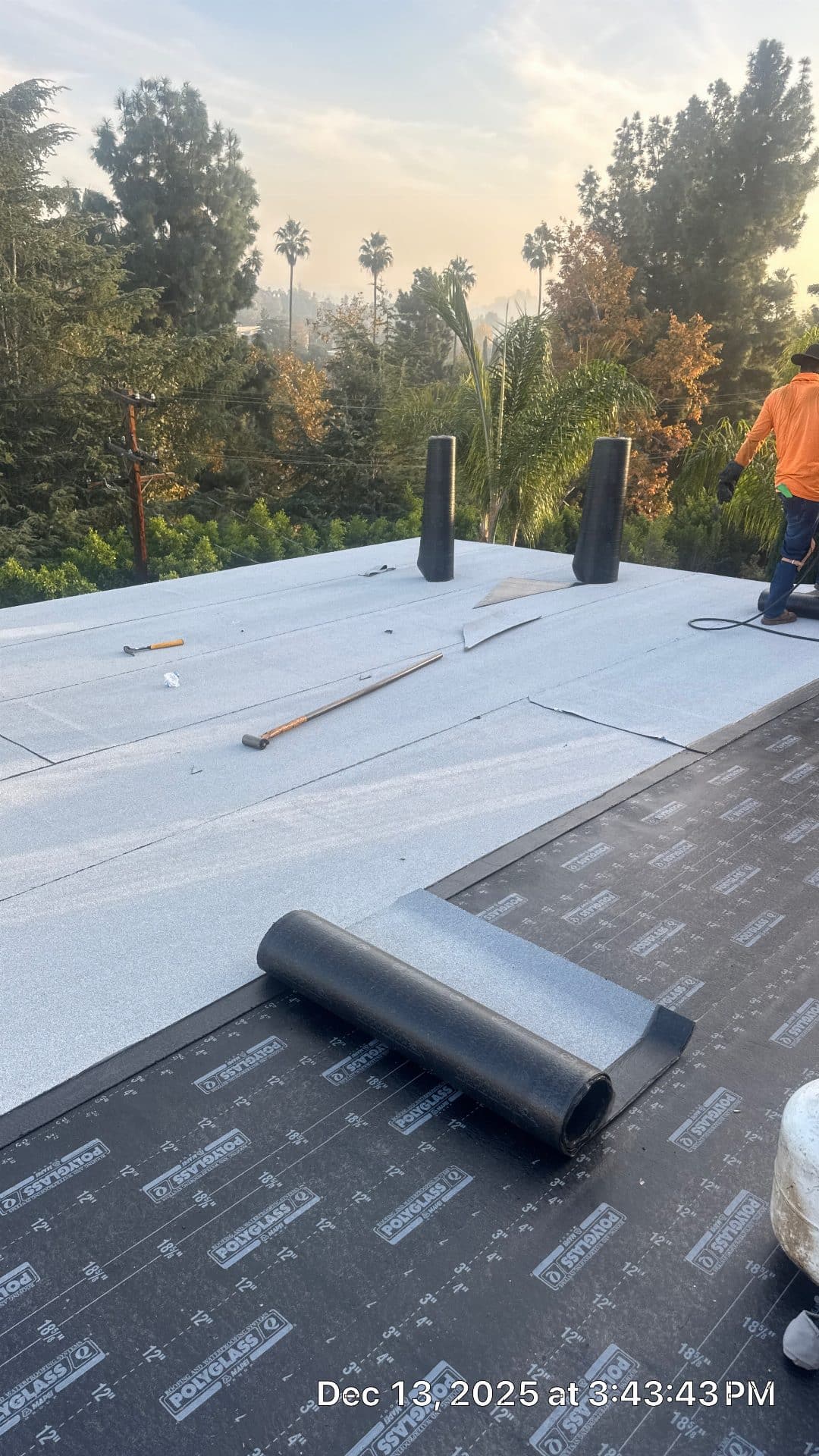Polyglass modified bitumen cap sheet being installed on flat roof — Glendale — Roof Replacement Inc
