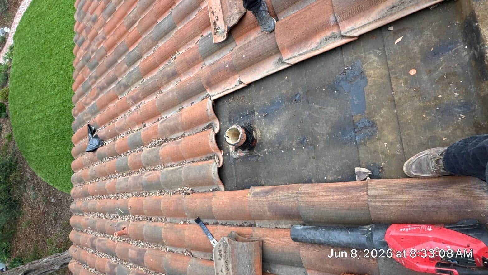 Different residential roofing material types including asphalt shingles, clay tile, and metal panels on a California home roof