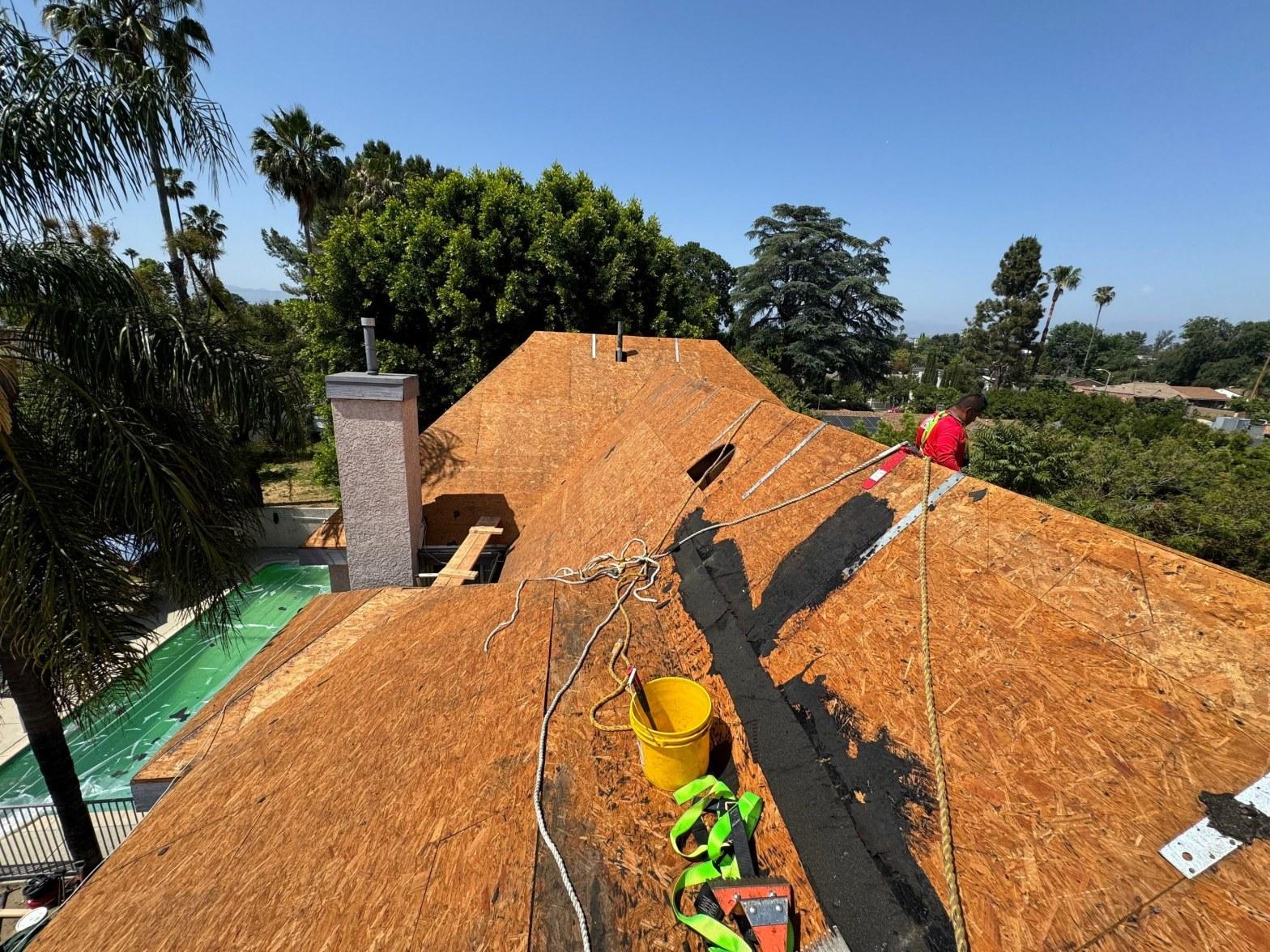 Bare OSB roof decking exposed after full shingle tear-off on a California residential home